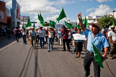 Demonstrators marching in Cancún